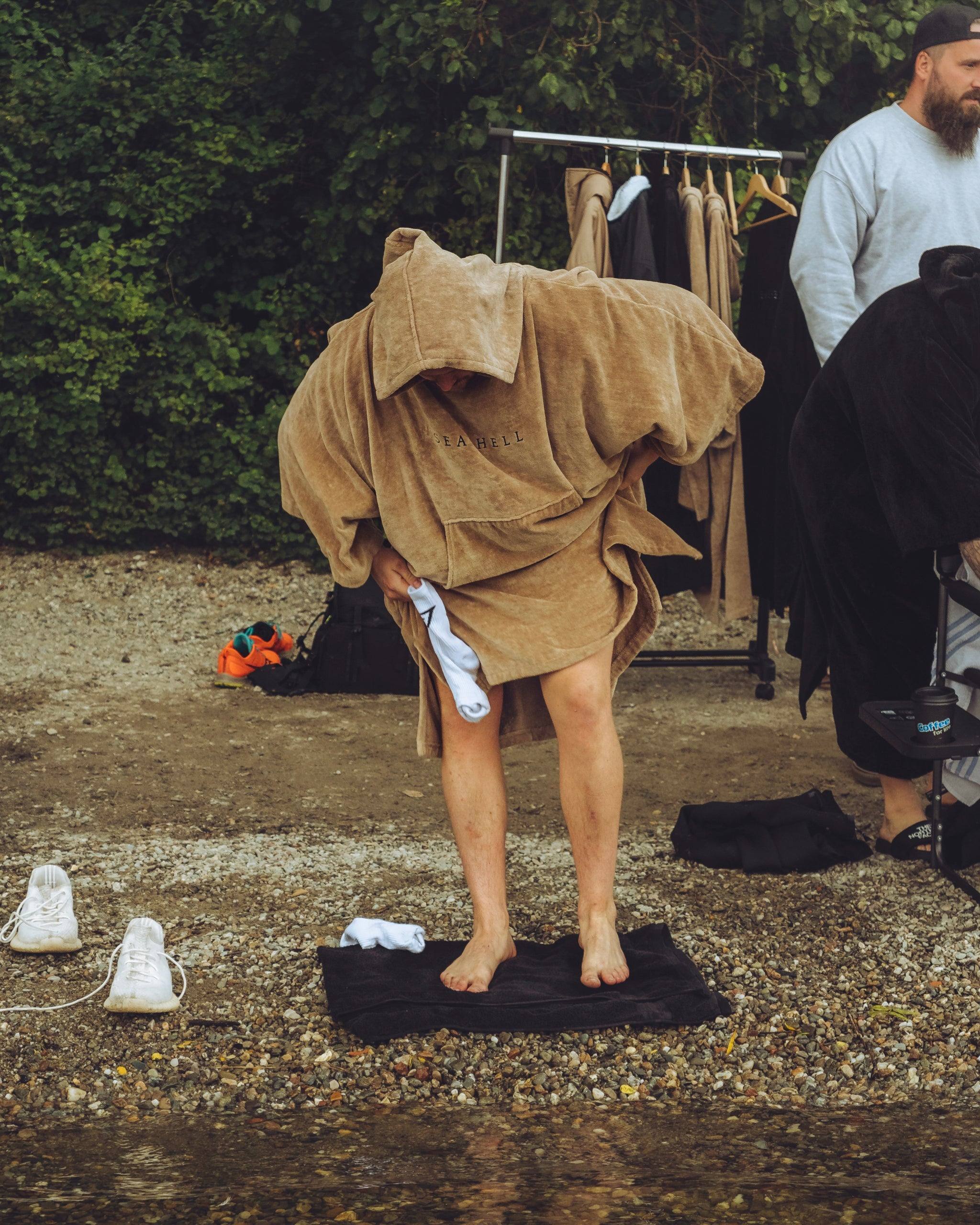 Changing under the towelling robe on a changing mat