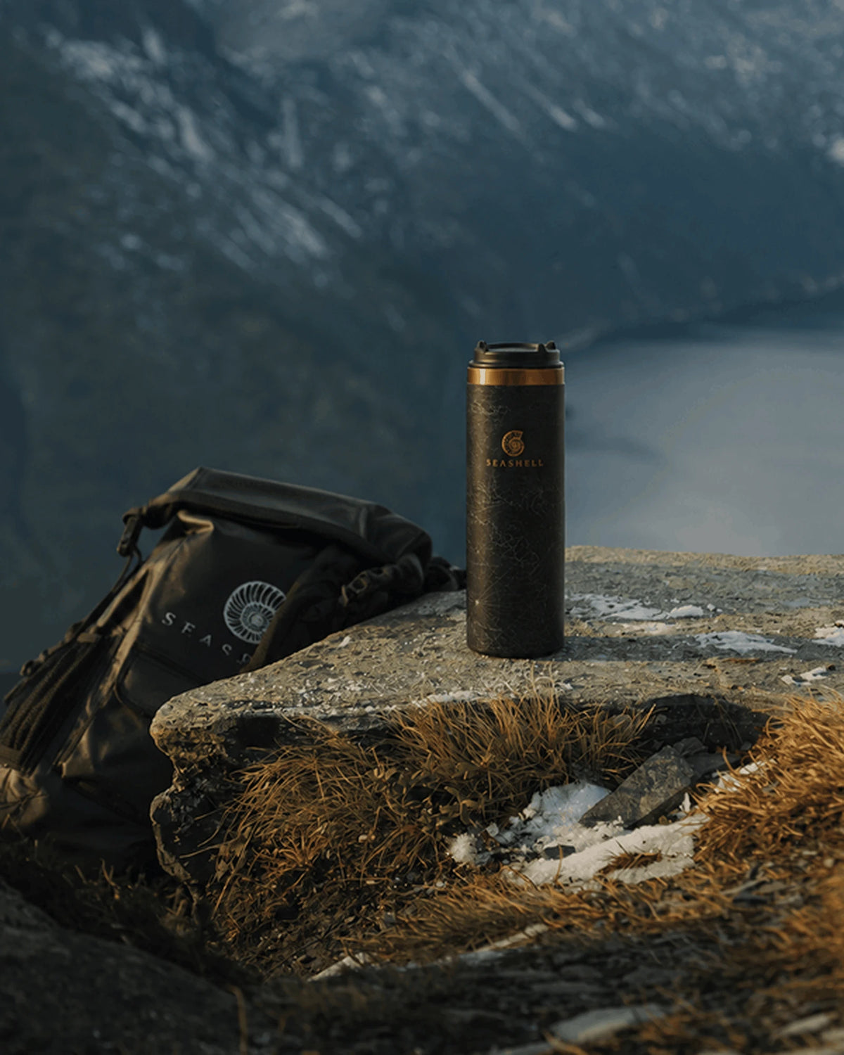 Black Flip Top Flask on a mountain ledge above a fjord