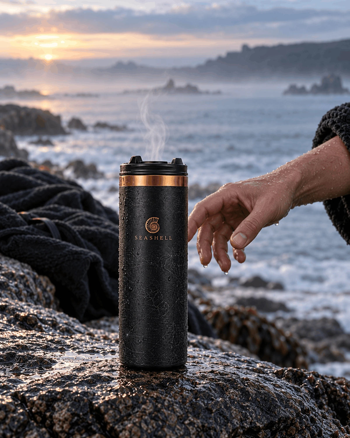 Black Flip Top Flask on wet sea rocks at sunrise after a cold-water swim