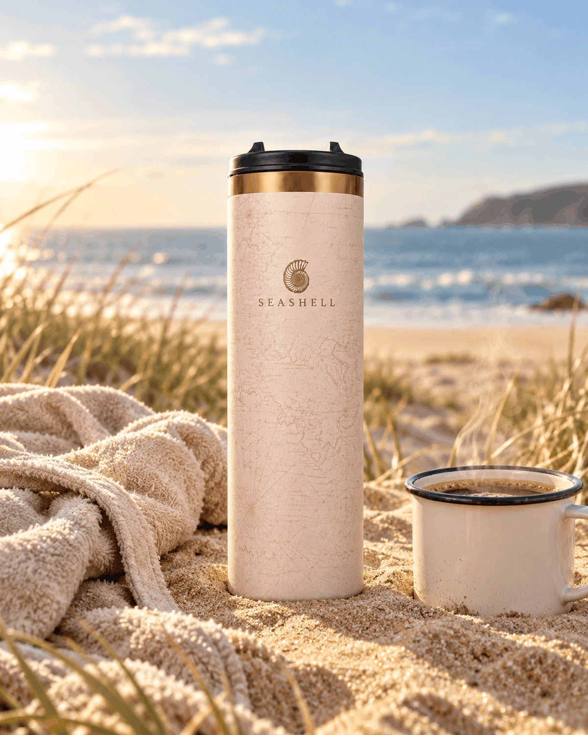 Sand Flip Top Flask on the beach with a towel and enamel coffee cup