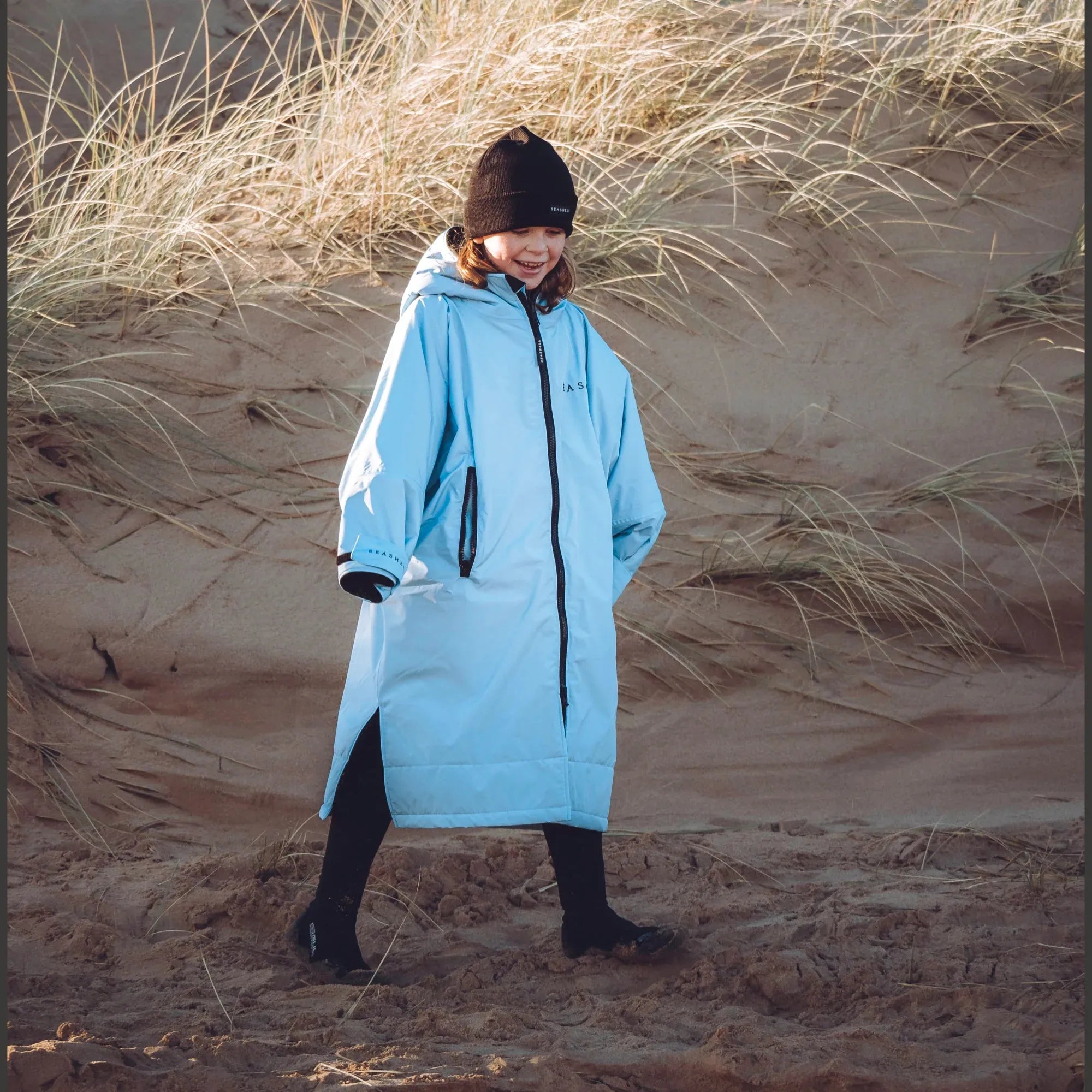 Kids Seashell changing robe in ocean, being worn at the beach